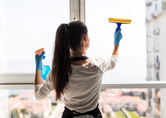 Professional window cleaner servicing a commercial building in Waterford