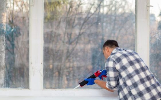Cleaner wiping dust and debris from windows after construction work in Waterford